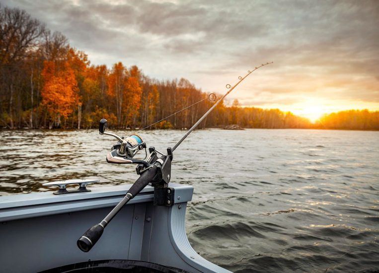 Kuvassa kaunis järvimaisema veneen matkustajan näkymässä näkyy veneen perä ja virveli.